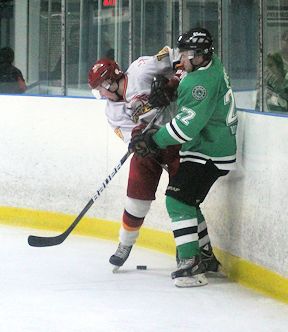 Evan Ducharme (L) of Lucknow, and David Jones of the Wolves fight for the puck